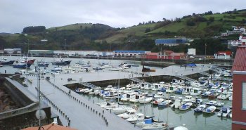 Panorámica del puerto viejo de Bermeo con sus casas de colores y las embarcaciones pesqueras amarradas