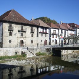 Panorámica de Ochagavía con sus casas de tejados empinados junto al río Anduña y el puente de piedra
